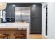 Close up of the kitchen island with bar stools and stainless steel appliances at 2231 Fairoaks Rd, Decatur, GA 30033