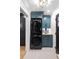 Modern laundry area features a stacked washer/dryer and sleek teal cabinetry at 2231 Fairoaks Rd, Decatur, GA 30033