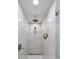 All white shower featuring rainfall head, storage space, and shower head at 2231 Fairoaks Rd, Decatur, GA 30033