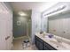 Clean bathroom featuring double sinks, with white tile floors, and framed mirrors at 4972 Arbor View Nw Pkwy, Acworth, GA 30101