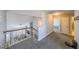 Hallway with hardwood railing, view to the living room, and doors to other rooms at 4972 Arbor View Nw Pkwy, Acworth, GA 30101