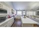 White kitchen with modern appliances, a large island with seating, and a window overlooking the yard at 4972 Arbor View Nw Pkwy, Acworth, GA 30101