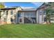 Expansive backyard with lush green grass and view of the home's rear, featuring a screened porch and wooden deck at 772 Crescent Cir, Canton, GA 30115