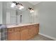 Large vanity in bathroom features double sinks, large mirror, and decorative lighting at 772 Crescent Cir, Canton, GA 30115