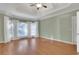 Bedroom featuring a tray ceiling, large windows, and neutral decor at 772 Crescent Cir, Canton, GA 30115