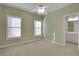 Bedroom with neutral carpet, fan, and a bathroom view at 772 Crescent Cir, Canton, GA 30115