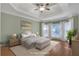 Bedroom featuring a tray ceiling, large windows, and neutral decor at 772 Crescent Cir, Canton, GA 30115