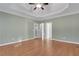 Bedroom featuring a tray ceiling, large windows, and neutral decor at 772 Crescent Cir, Canton, GA 30115