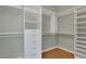 Walk-in closet with built-in shelving and storage drawers at 772 Crescent Cir, Canton, GA 30115