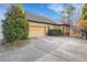 Spacious driveway leading to a two-car garage, surrounded by mature trees at 772 Crescent Cir, Canton, GA 30115