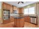 Kitchen with stainless appliances, kitchen island, and hardwood flooring at 772 Crescent Cir, Canton, GA 30115