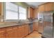 Kitchen with stainless steel appliances, granite counters, and wooden cabinets at 772 Crescent Cir, Canton, GA 30115