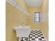 Laundry room with a black and white checkered floor and wire shelving at 772 Crescent Cir, Canton, GA 30115