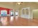 Bright living room featuring hardwood floors, a red accent wall, and a large bookcase at 772 Crescent Cir, Canton, GA 30115