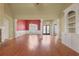 Bright living room with hardwood floors, an accent wall, and a large entryway with an ornate glass door at 772 Crescent Cir, Canton, GA 30115