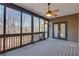 Relaxing screened porch with a ceiling fan, wood floors, and views of the surrounding woods and nature at 772 Crescent Cir, Canton, GA 30115