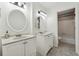 Well-lit bathroom featuring double vanity sinks, tiled floors, and a full-size shower and tub combination at 4072 Whispering Forest Ct, Lilburn, GA 30047