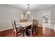 Dining room with a rustic wooden table and a view into the kitchen at 4072 Whispering Forest Ct, Lilburn, GA 30047