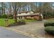 A two-story home with a brick facade and a well-maintained front yard and driveway at 4072 Whispering Forest Ct, Lilburn, GA 30047