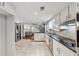 Bright kitchen with white cabinets, stainless steel appliances, and a view to the living area at 4072 Whispering Forest Ct, Lilburn, GA 30047