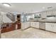 Large open kitchen flows into a living space, featuring white cabinets and black countertops at 4072 Whispering Forest Ct, Lilburn, GA 30047