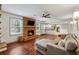 Inviting living room with brick fireplace, TV, and view to the kitchen, creating a warm atmosphere at 4072 Whispering Forest Ct, Lilburn, GA 30047