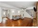 Bright living room with hardwood floors, fireplace, and stairway, perfect for entertaining and relaxation at 4072 Whispering Forest Ct, Lilburn, GA 30047