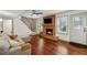 Cozy living room featuring hardwood floors, a brick fireplace, and a comfortable sectional sofa at 4072 Whispering Forest Ct, Lilburn, GA 30047