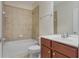 Cozy bathroom with tile shower, white fixtures, and wood vanity at 4669 Prater Se Way, Smyrna, GA 30080