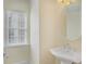 Half-bathroom with a pedestal sink and a window that provides natural light at 4669 Prater Se Way, Smyrna, GA 30080