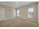 Bright, carpeted bedroom with two windows and a neutral color scheme at 4669 Prater Se Way, Smyrna, GA 30080