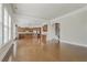 Open living room with hardwood floors connecting to a kitchen and staircase at 4669 Prater Se Way, Smyrna, GA 30080