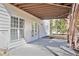 Back patio under deck with white windows, a door, and wood stairs at 4669 Prater Se Way, Smyrna, GA 30080