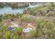 Aerial view of a gorgeous home nestled amongst lush trees near a lake at 5975 P W A Dr, Cumming, GA 30041