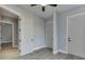 An interior bedroom shot showcases the gray walls, white trim, and two closets, with the doorway opening to another room at 5975 P W A Dr, Cumming, GA 30041