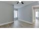 Bright bedroom featuring light gray walls, white trim, a ceiling fan, and a window with natural light, offering a calming retreat at 5975 P W A Dr, Cumming, GA 30041