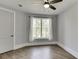 Bedroom featuring hardwood floors, a ceiling fan, and a window with sheer curtains at 5975 P W A Dr, Cumming, GA 30041