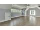 Spacious bonus room featuring wood floors, high ceilings, recessed lighting, and storage options at 5975 P W A Dr, Cumming, GA 30041