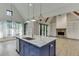 Modern kitchen with a blue island, granite countertops, and stainless steel appliances at 5975 P W A Dr, Cumming, GA 30041