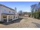 Spacious fenced backyard featuring a covered patio and a gravel fire pit at 4525 Chelton Se Ct, Smyrna, GA 30080
