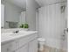 Bathroom with white vanity, large mirror, shower with curtain, and tile floor at 4525 Chelton Se Ct, Smyrna, GA 30080