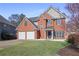 Charming two-story brick home with a well-manicured lawn and a two-car garage at 4525 Chelton Se Ct, Smyrna, GA 30080