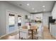 Bright kitchen featuring white cabinets, granite countertops, and a dining area with access to the backyard at 4525 Chelton Se Ct, Smyrna, GA 30080