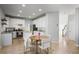 Well-lit kitchen with white cabinets, stainless steel appliances, and a cozy dining area at 4525 Chelton Se Ct, Smyrna, GA 30080