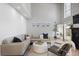 Spacious living room showcases a large sectional sofa, high ceilings, a fireplace, and modern decor at 4525 Chelton Se Ct, Smyrna, GA 30080