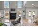 Bright living room with high ceilings, a fireplace, large windows, and access to the outdoor space at 4525 Chelton Se Ct, Smyrna, GA 30080