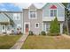 Charming townhome featuring a cozy front yard and colorful facade at 6657 Witherington Ct, Norcross, GA 30093