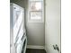 Laundry space with stacked washer and dryer, efficient use of vertical room with window at 6657 Witherington Ct, Norcross, GA 30093