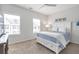 A bright bedroom with two large windows provides natural light for the room with a ceiling fan and modern decor at 6785 Pippin Walk, Alpharetta, GA 30005