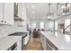 Bright, open kitchen featuring white cabinets, stainless steel appliances, and a view into the living room at 6785 Pippin Walk, Alpharetta, GA 30005